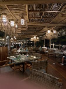 een restaurant met tafels, stoelen en kroonluchters bij Vidanta 2-bdrm Villa, in Nuevo Vallarta 