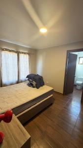 En eller flere senge i et værelse på Cabañas olmue