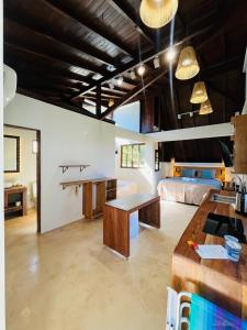 a large living room with a table and a bed at Studio Na Natureza Com Hidro - Baoba Suites in Bombinhas