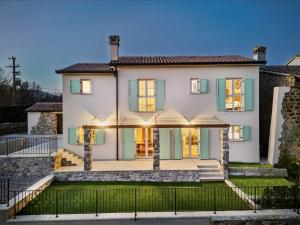 una grande casa bianca con persiane verdi di Vacation Home Amore a Motovun (Montona)