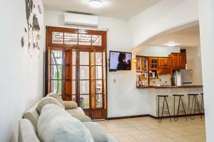 a living room with a couch and a kitchen at Esencia de Montaña in El Challao