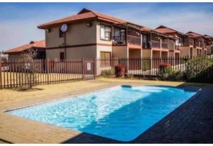 a swimming pool in front of a house at Mama R's unit 88 in Newcastle