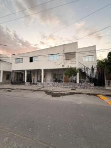 a large white building with stairs in front of it at Apartamento completo in Santa Marta