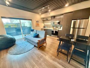a living room with a couch and a kitchen at Luxury Central City Escape in Salt Lake City