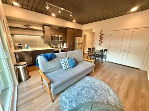 a living room with a couch and a kitchen at Luxury Central City Escape in Salt Lake City
