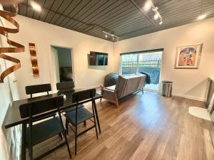 a living room with a table and chairs and a couch at Luxury Central City Escape in Salt Lake City