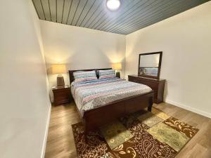 a bedroom with a bed and two lamps and a mirror at Luxury Central City Escape in Salt Lake City