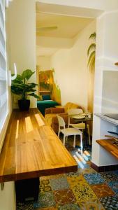 a living room with a wooden table and a couch at Mozaïka - Le cocon tropical in Pointe-à-Pitre
