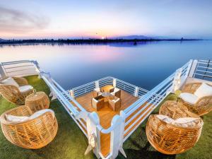 a boat with chairs and a table on the water at Mövenpick MS Sunray in Luxor