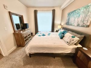 a bedroom with a bed and a television in it at Spacious 2-Bedroom Urban Oasis in Salt Lake City