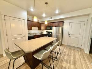 a kitchen with a table and chairs and a refrigerator at Spacious 2-Bedroom Urban Oasis in Salt Lake City