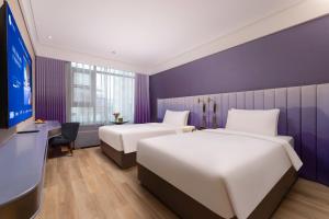 Postel nebo postele na pokoji v ubytování Manxin Hotel, Guanqian Street, Suzhou + 16 fotografií