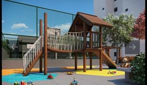 a playground with a slide in a park at Apto frente o mar com 3 piscinas Wi-Fi gratuito aceito pet in Mongaguá