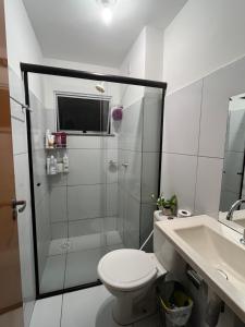 a bathroom with a shower and a toilet and a sink at Village do Sol 3 - Apt compartilhado in Maioba