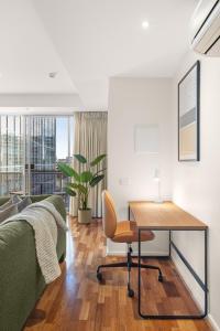 a bedroom with a bed and a desk in a room at Nolo Apartments Lonsdale St in Melbourne