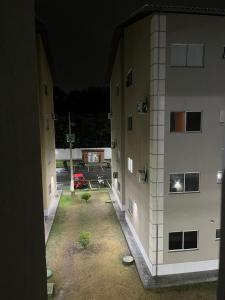 a view from a window of two buildings at night at Village do Sol 3 - Apt compartilhado in Maioba