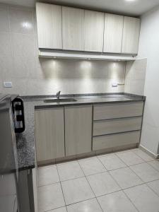 a kitchen with a sink and a counter top at Departamento PA in Villa Carlos Paz