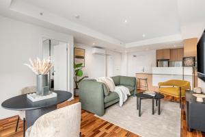 a living room with a couch and a table at Nolo Apartments Lonsdale St in Melbourne