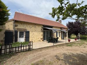 a yellow house with a fence in front of it at Charmante fermette avec jardin, animaux acceptés - FR-1-489-87 in Bourbon-lʼArchambault
