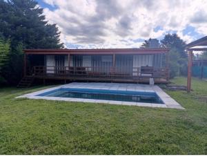 a house with a swimming pool in the yard at Cabaña Habibi in Potrero de Garay