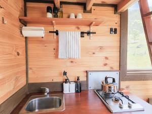 a kitchen with a sink in a tiny house at Anakie Gorge Getaway Tiny House 1 by Tiny Away in Staughton Vale