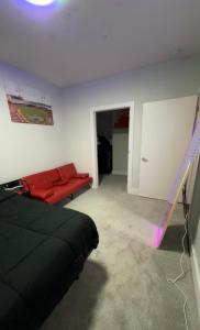 a living room with a red couch in a room at The 513 Flat 2! 1BR, 1Bath Apt with Pool and Riverfront View! Free Gated Parking! Only Steps from The banks & Stadiums! in Cincinnati +22 photos