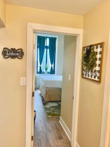 a bedroom with a bed and a window with blue curtains at The Nest At Twelve in Detroit