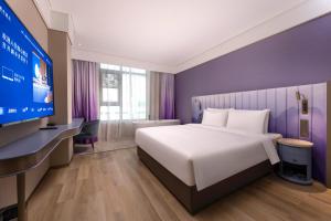 Postel nebo postele na pokoji v ubytování Manxin Hotel, Guanqian Street, Suzhou