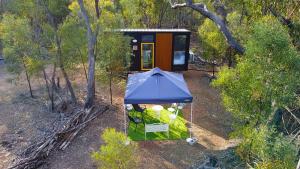 an overhead view of a tiny house with a blue roof at BushLights Glade by Tiny Away in Dalby