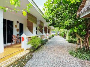 a walkway next to a house with a table at Nautilus Hostel & Hammocks in Panglao Island