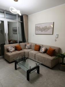 a living room with a couch and a glass table at koi Residencial 301 in Chimbote