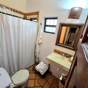 a bathroom with a sink and a toilet and a mirror at Hotel Casa Morena in San Miguel de Allende +60 photos