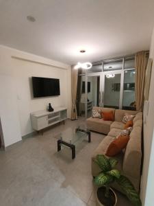 a living room with a couch and a flat screen tv at koi Residencial 301 in Chimbote