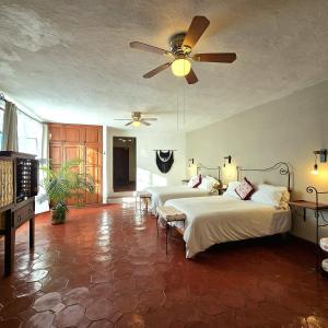a bedroom with two beds and a ceiling fan at Hotel Casa Morena in San Miguel de Allende