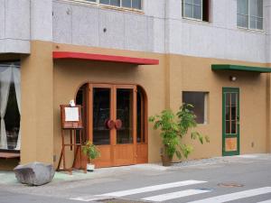a building with a door and a sign in front of it at horn ホルン in Kofu +21 photos