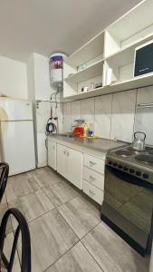 a kitchen with a stove and a refrigerator at Satya park in Mar del Plata