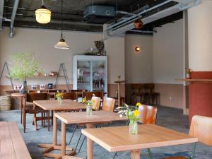 a dining room with wooden tables and chairs at horn ホルン in Kofu