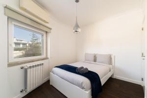 En eller flere senge i et værelse på São Pedro Beach Villa