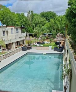 a swimming pool in a yard with a house at Complejo Viri Viri - Gualeguaychú in Gualeguaychú +68 photos