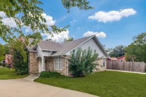a house with a fence in a yard at Historic Downtown McKinney 3BR in McKinney