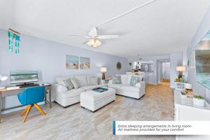 een woonkamer met witte meubels en een plafondventilator bij Canaveral Sands 4202 in Cape Canaveral