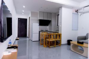 a kitchen and a living room with a table at A Letter from the Sea Breeze in Beihai +26 photos