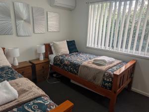 En eller flere senge i et værelse på Birdsong Central, North Beach