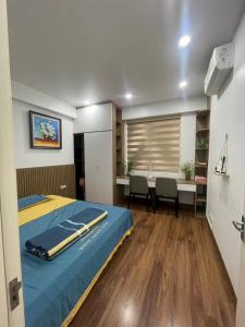 a bedroom with a bed and a table and chairs at The Timegarden Homestay in Ha Long