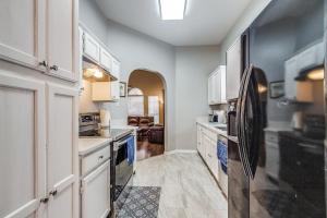 eine große Küche mit weißen Schränken und Geräten in der Unterkunft Historic Downtown McKinney 3BR in McKinney