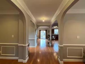 an empty room with a hallway with wood floors and ceilings at 25 Lux King Suite 1 - Private Bath, Nonsmoking in Arlington