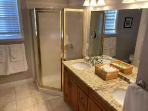 a bathroom with two sinks and a shower at 25 Lux King Suite 1 - Private Bath, Nonsmoking in Arlington