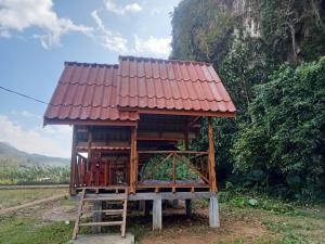 a small house with a red roof on a field at Phathokcamping in Ban Phathok +8 photos