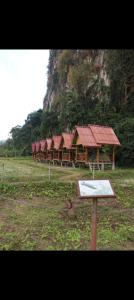 a group of buildings with red roofs in a field at Phathokcamping in Ban Phathok
