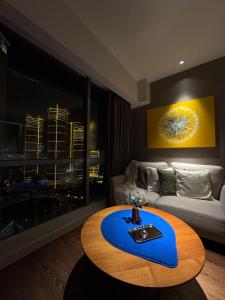 a living room with a table and a couch at Hotel Residence at Novotel in Manila +19 photos